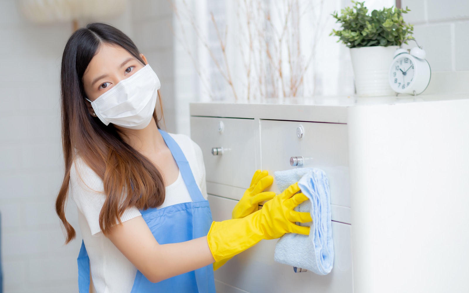 Woman cleaning cabinet